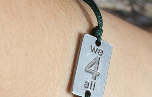 WE4ALL BRACELET WITH METAL LOGO AND GREEN CORD
